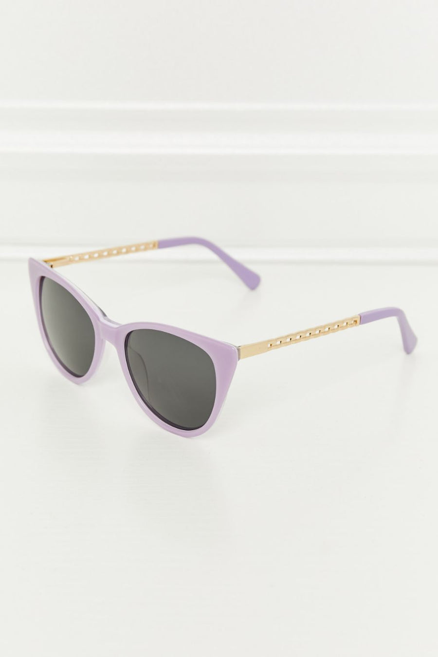 Lavender cat-eye acetate sunglasses with gold chain detail on temples