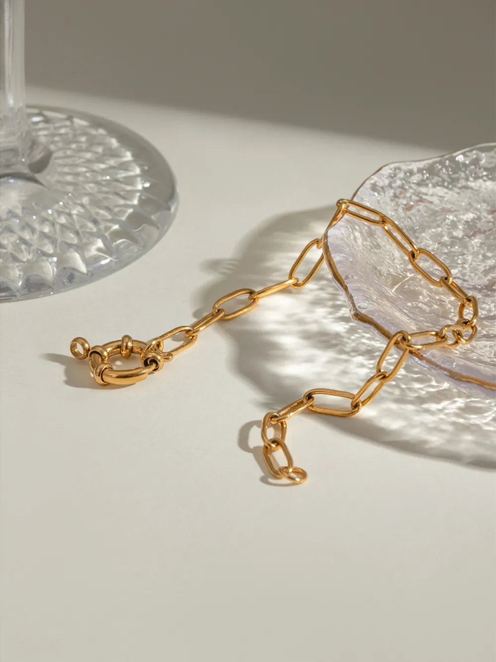 Gold chunky link bracelet with a circular toggle clasp
