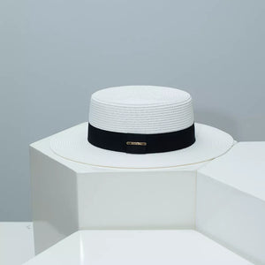 White straw boater hat with black band and gold detail