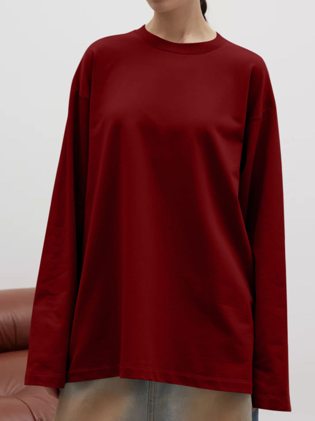 Burgundy oversized crewneck sweatshirt with voluminous sleeves and a relaxed fit.