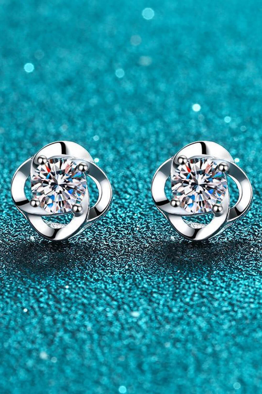 Silver stud earrings with clear square-cut gems and clover design
