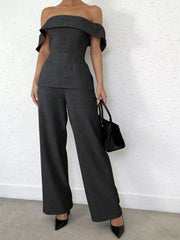 Chic dark gray off-shoulder top and wide-leg pants set with a structured bodice and flared sleeves.