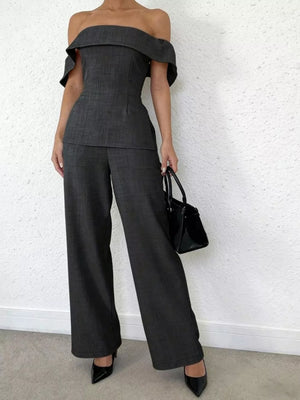 Chic dark gray off-shoulder top and wide-leg pants set with a structured bodice and flared sleeves.