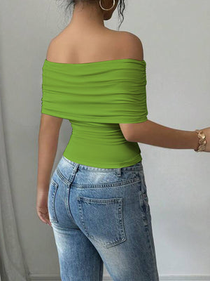 Green asymmetrical ruched off-shoulder top with short sleeves.