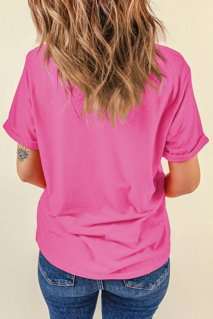 Pink t-shirt with rolled short sleeves and a crew neck.