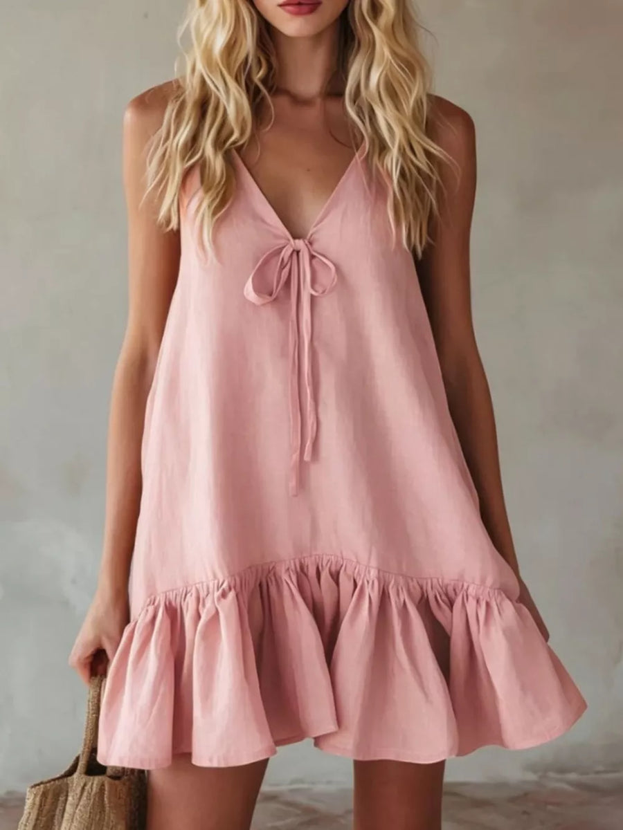 Pink tie-front mini dress with ruffle hem and V-neckline.