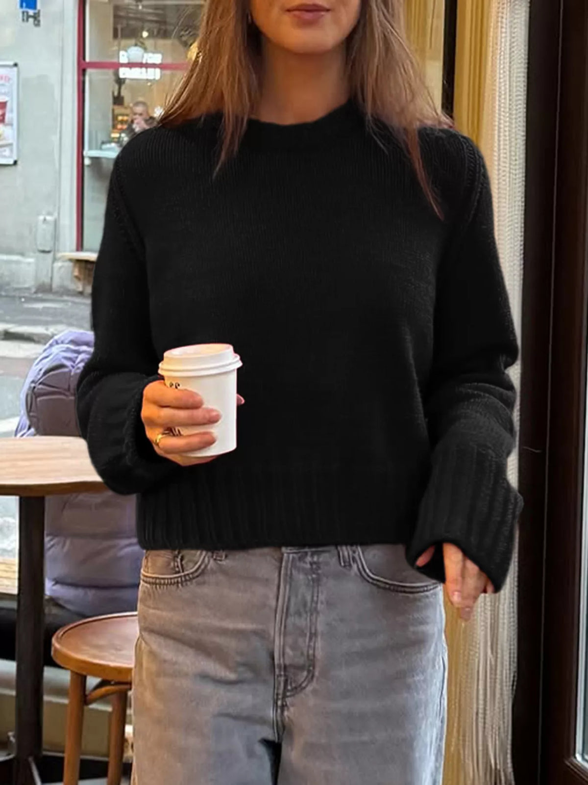 Black ribbed round-neck knit sweater with comfortable fit and wide cuffs.