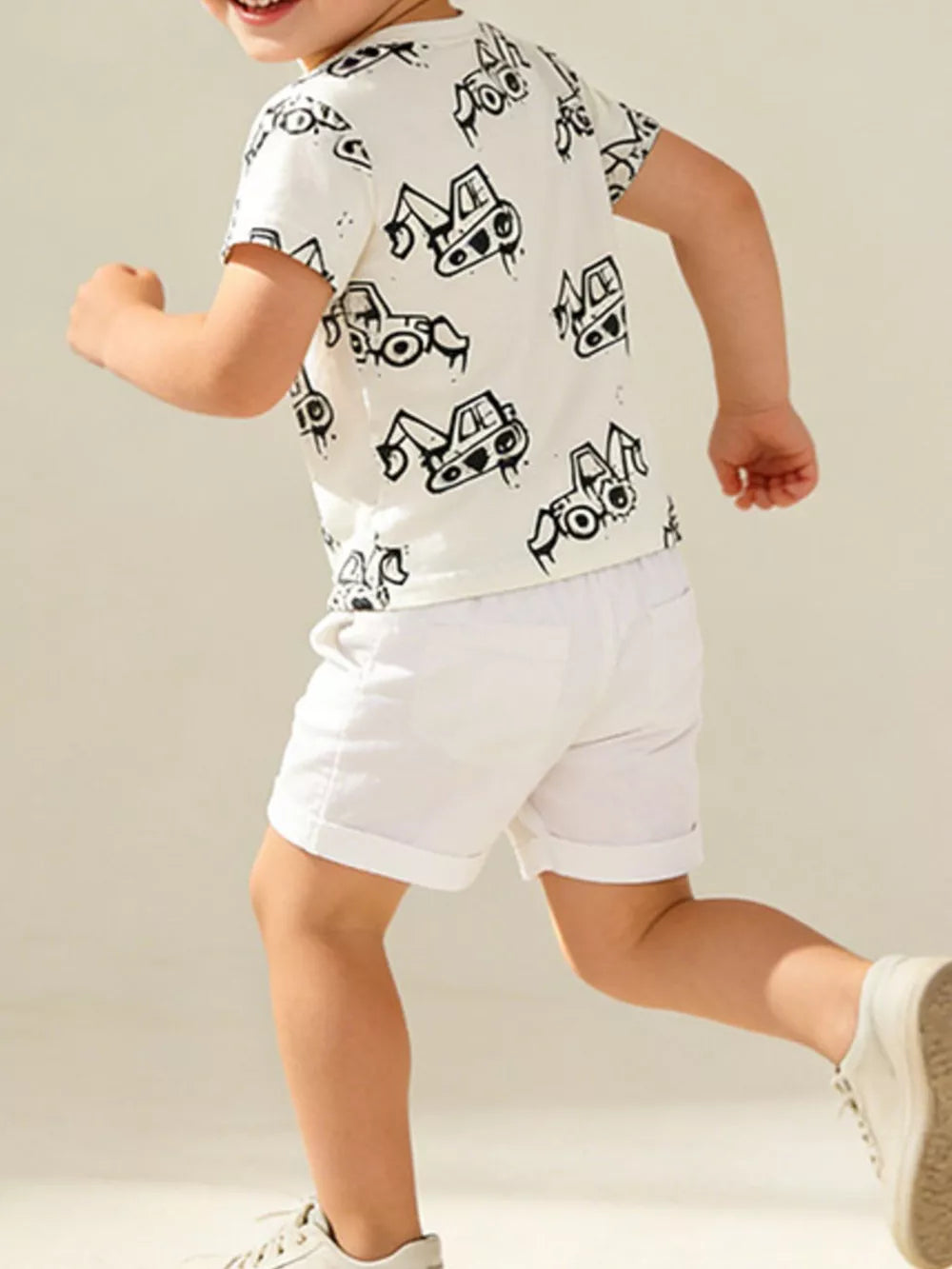 White cotton t-shirt with playful black excavator print, short sleeves, crew neck.