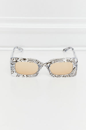 Swirl print rectangular frame sunglasses with tan lenses and black and white pattern.