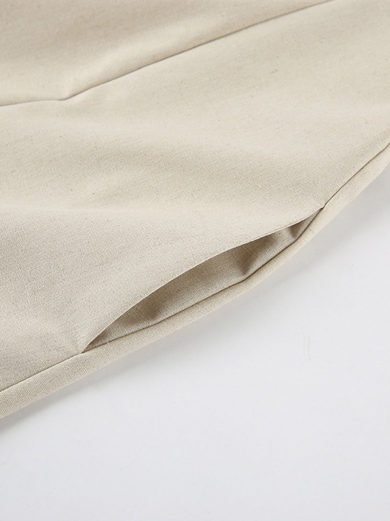 Beige smocked tube dress with zipper detail and pocket.