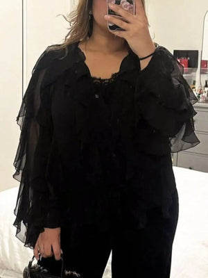 Black sheer long-sleeve blouse with ruffled details and lace trim.