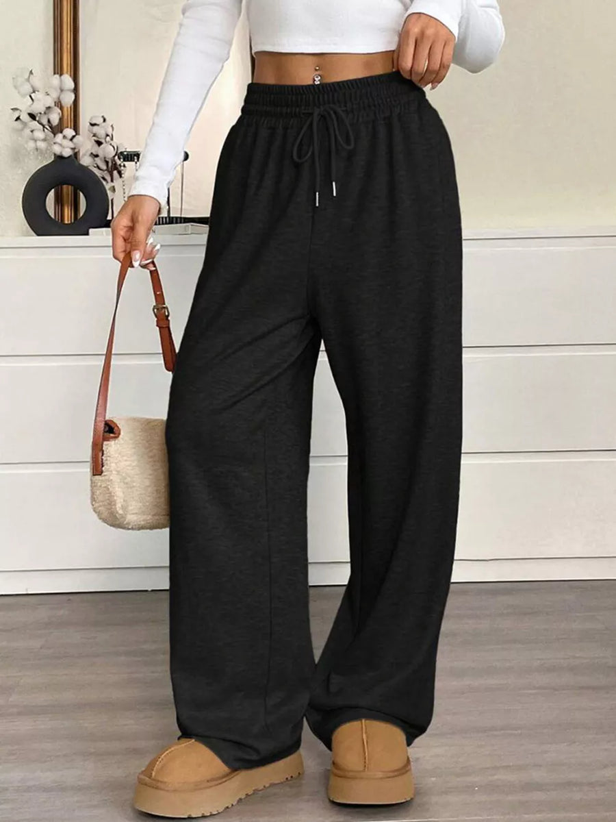 wide-leg pants in black featuring drawstring waist and wide-leg fit