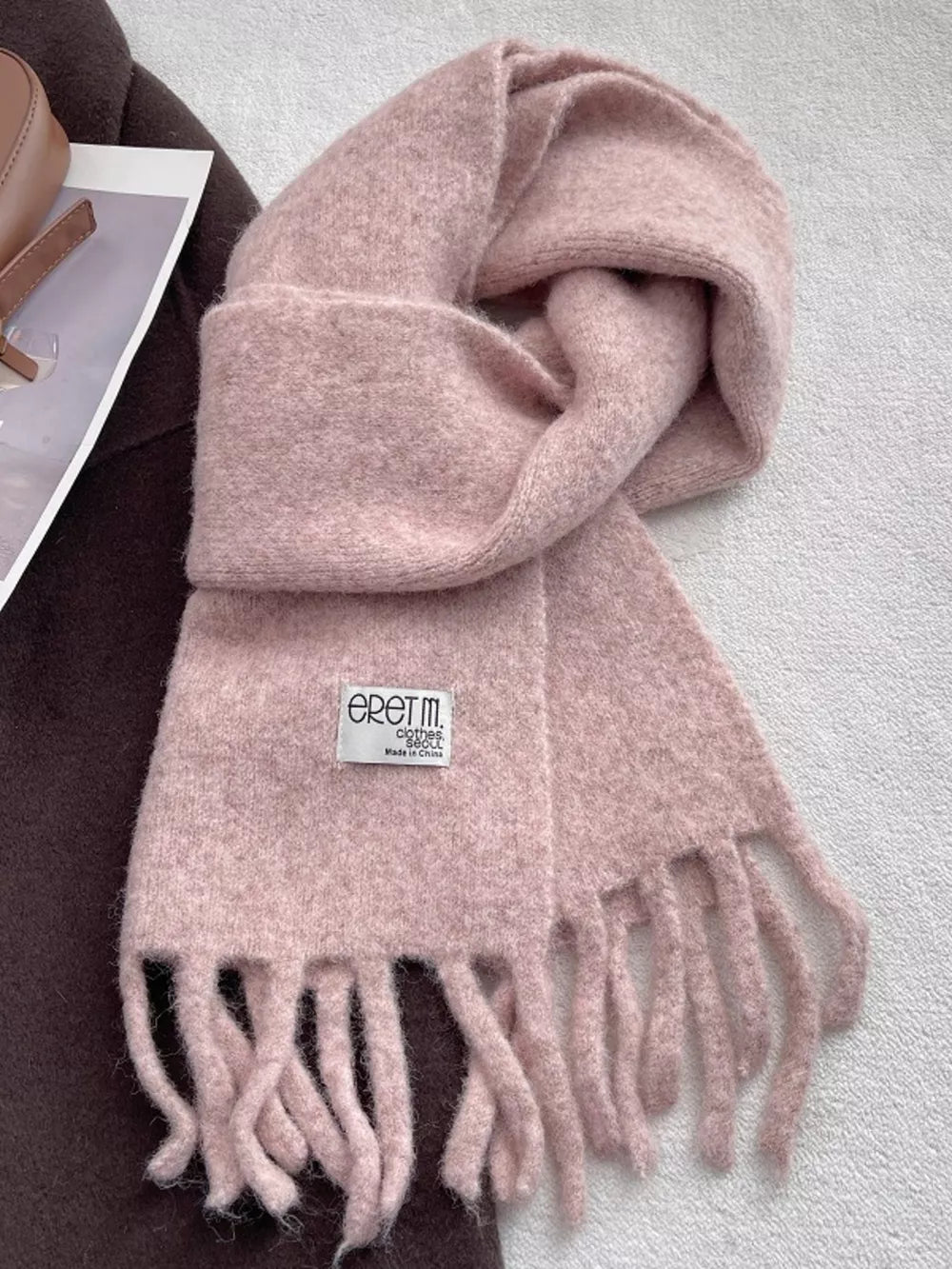 Plush fringe scarf in solid Cherry Blossom Powder with a soft, cozy texture.