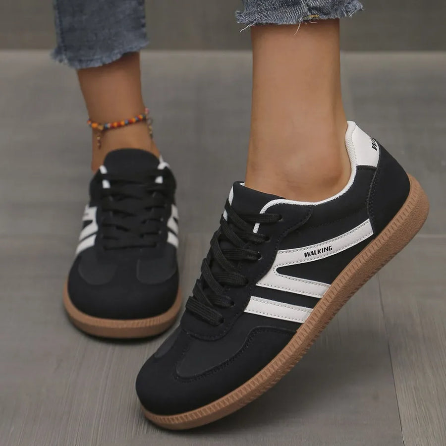 Black retro stripe walking sneakers with white accents and gum sole