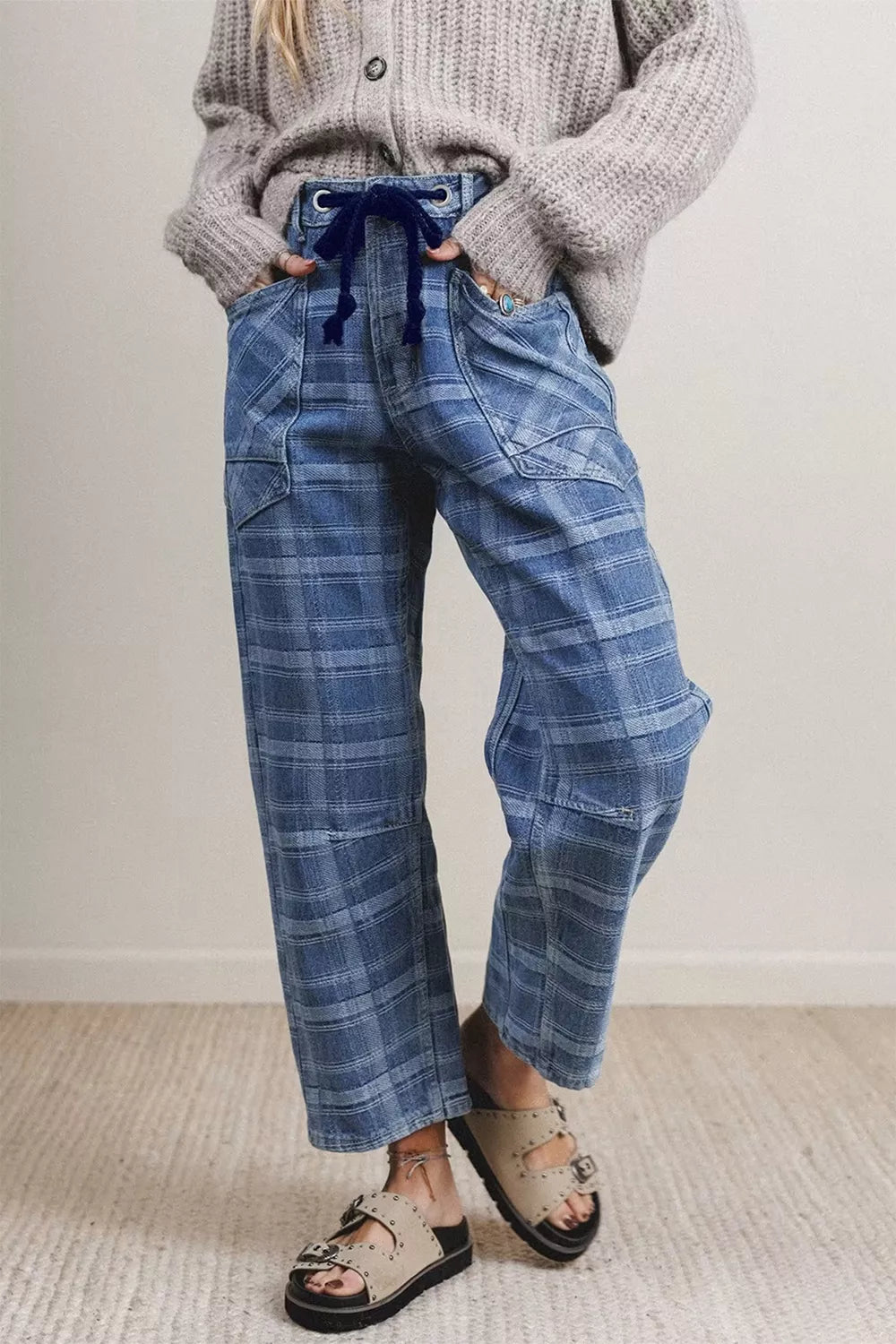 Plaid denim jeans with drawstring waist and grommets in dusty blue cotton.