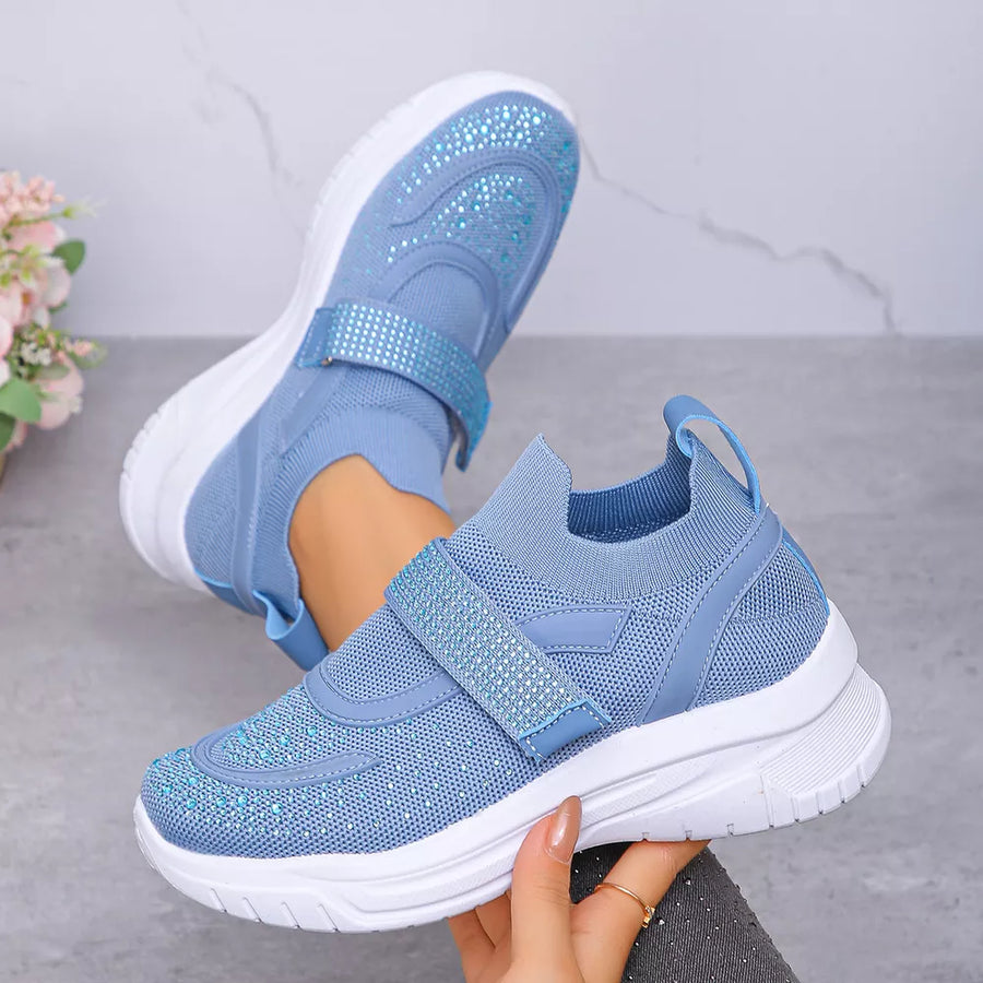 Blue mesh slip-on sneakers with adjustable straps adorned with rhinestones.