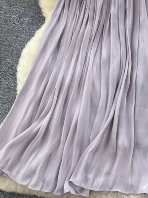 Pleated maxi skirt in light purple with flowing fabric and delicate pleats.
