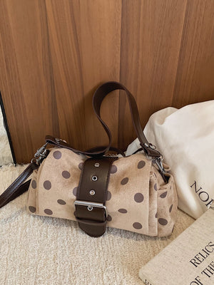 Brown shoulder bag featuring adjustable strap and polka-dot