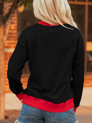 Black sweatshirt with red trim, long sleeves, and a relaxed fit.