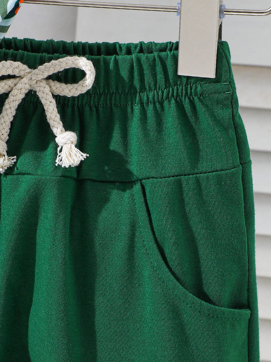 Dark green cotton baby shorts with drawstring and pocket detail.