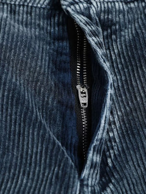 Blue corduroy cargo pants with a zipper detail and textured fabric.