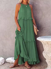 Green ruffled maxi dress with halter neck and tiered skirt.