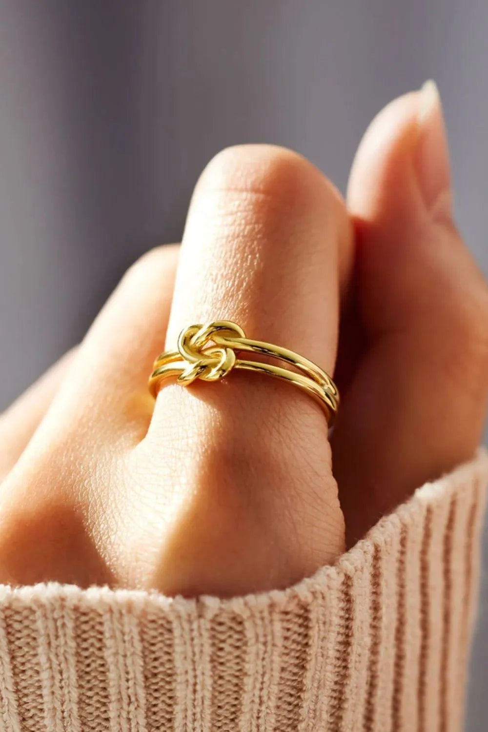 Gold double band knot ring with a casual, elegant design.