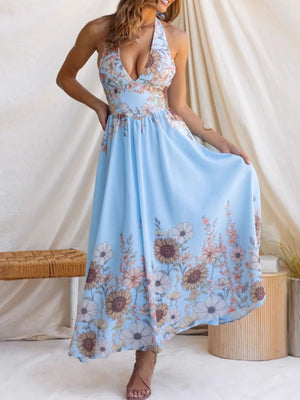 Blue floral halter neck maxi dress with plunging neckline and flowing skirt.