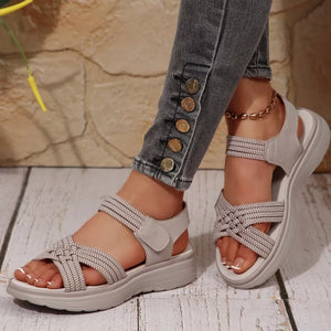 Khaki woven criss-cross platform sandals with adjustable strap and ankle bracelet.