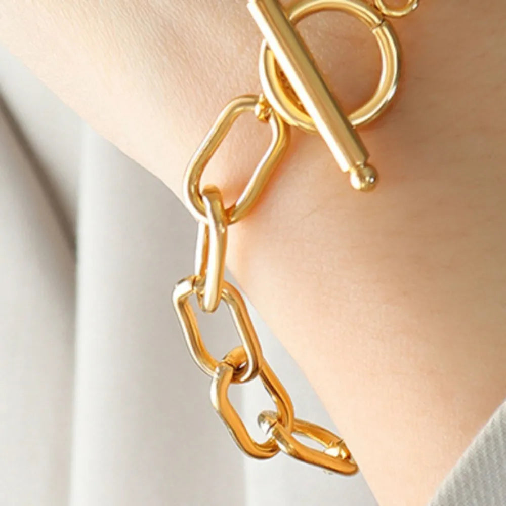 Gold chain-link bracelet with toggle closure and zirconia detail