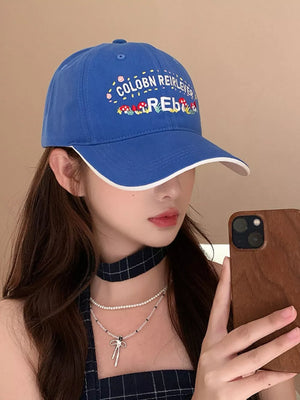 Blue baseball cap with playful embroidered mushrooms and text detail
