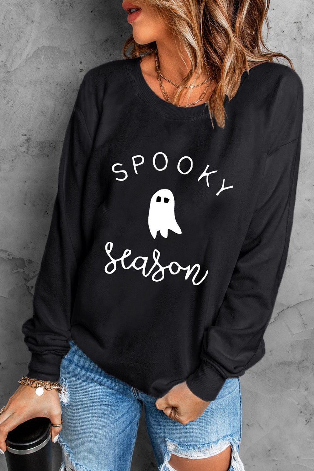 Black crewneck sweatshirt with white ghost and Spooky Season graphic.