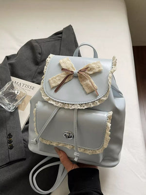 Blue mini backpack with lace trim and bow detail