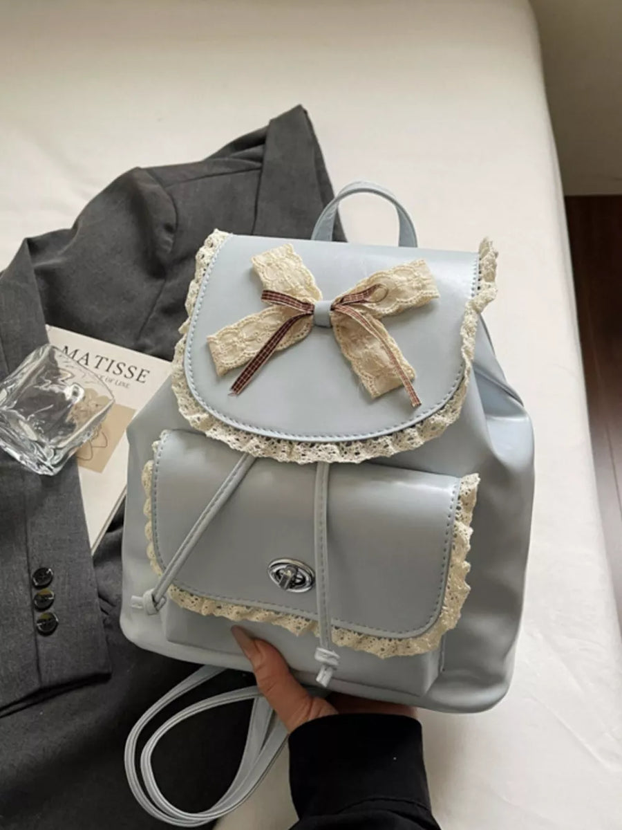 Blue mini backpack with lace trim and bow detail