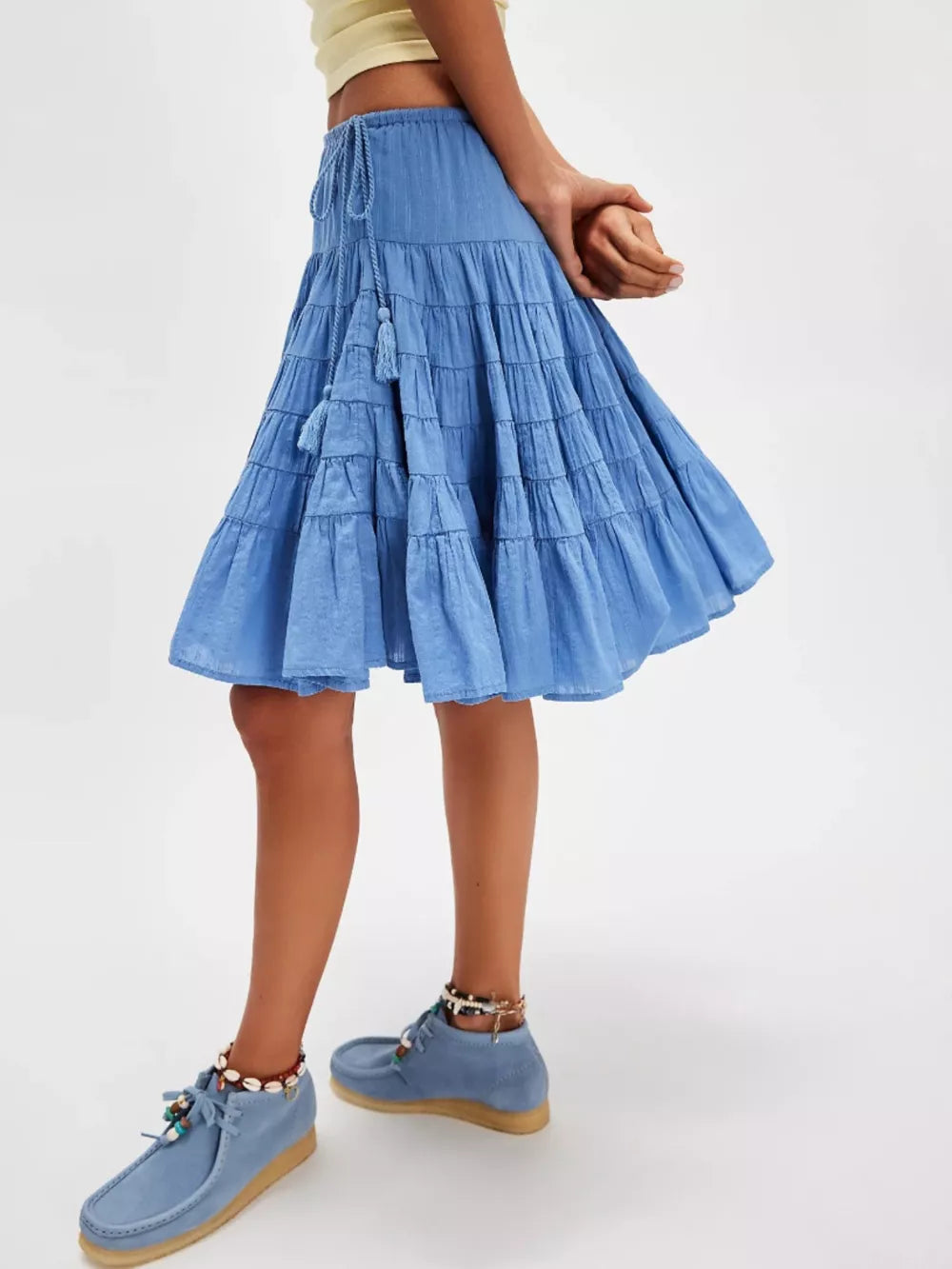 Tiered drawstring mini skirt in Sky Blue with tassel detail and a flowy cut.