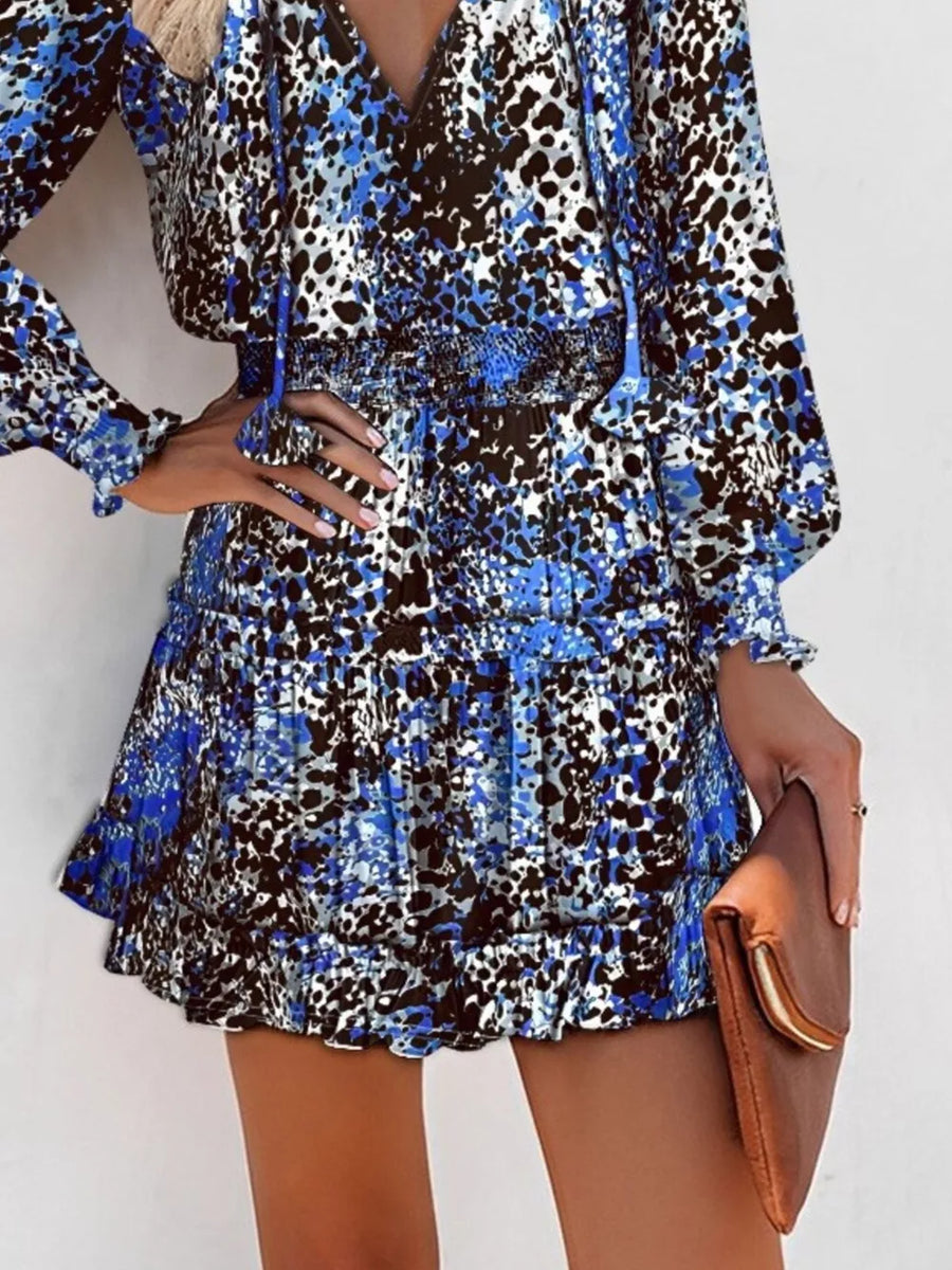 Blue leopard print tiered mini dress with ruffles and smocked waist.