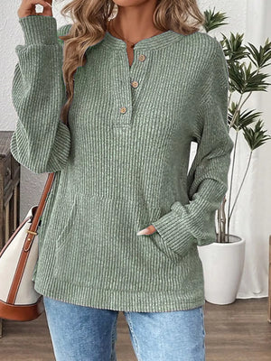 Light green ribbed long-sleeve top with button detail and front pocket.