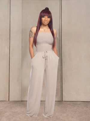 Strapless beige smocked jumpsuit with drawstring waist and wide legs