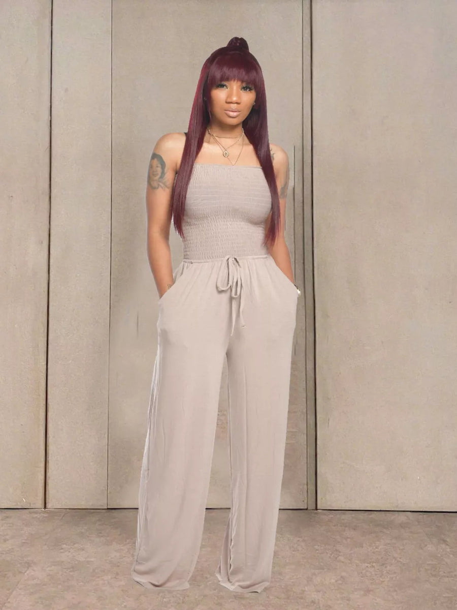 Strapless beige smocked jumpsuit with drawstring waist and wide legs