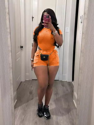 Orange ribbed crop top and pocket shorts set with chain belt detail.