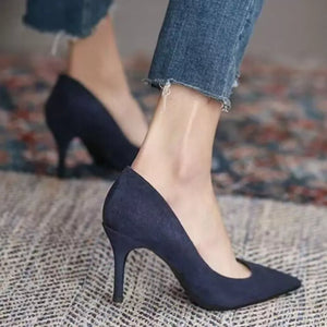 Sapphire blue suede point toe stiletto pumps with a classic silhouette.
