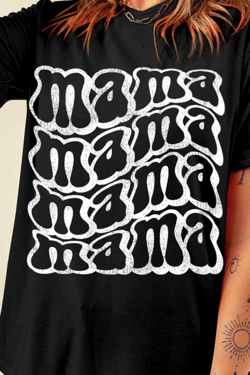 Black graphic tee with white "mama" text in a retro wavy font.