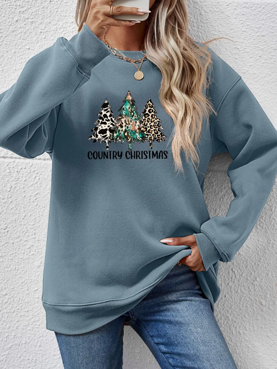 French Blue sweatshirt with country Christmas trees graphic and leopard print detail.