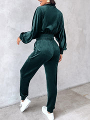 Velvet track jacket in deep teal with cinched waist and balloon sleeves, paired with matching pants.