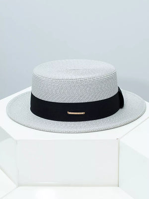 Gray straw boater hat with black ribbon and gold accent detail
