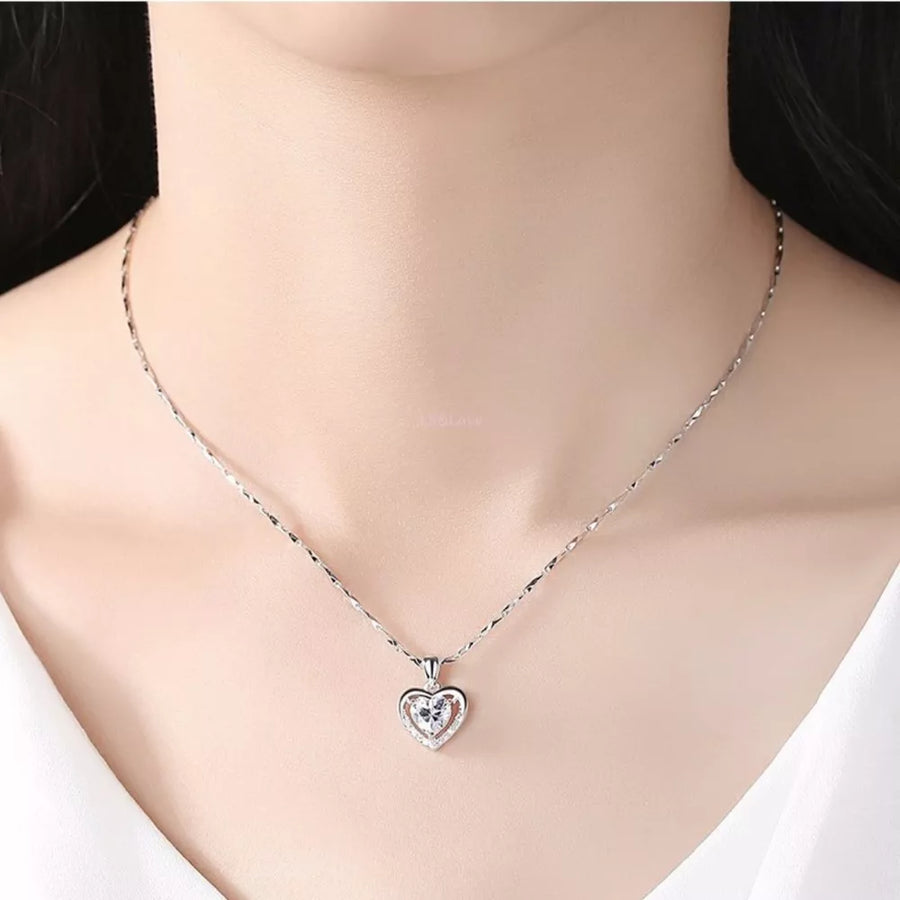 Silver chain necklace with a heart pendant featuring a clear zircon stone.