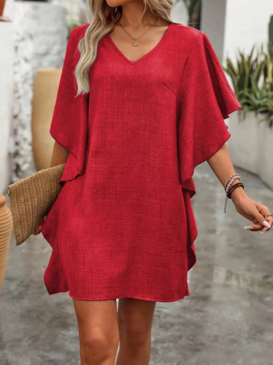 Red V-neck mini dress with flowy sleeves and textured fabric.