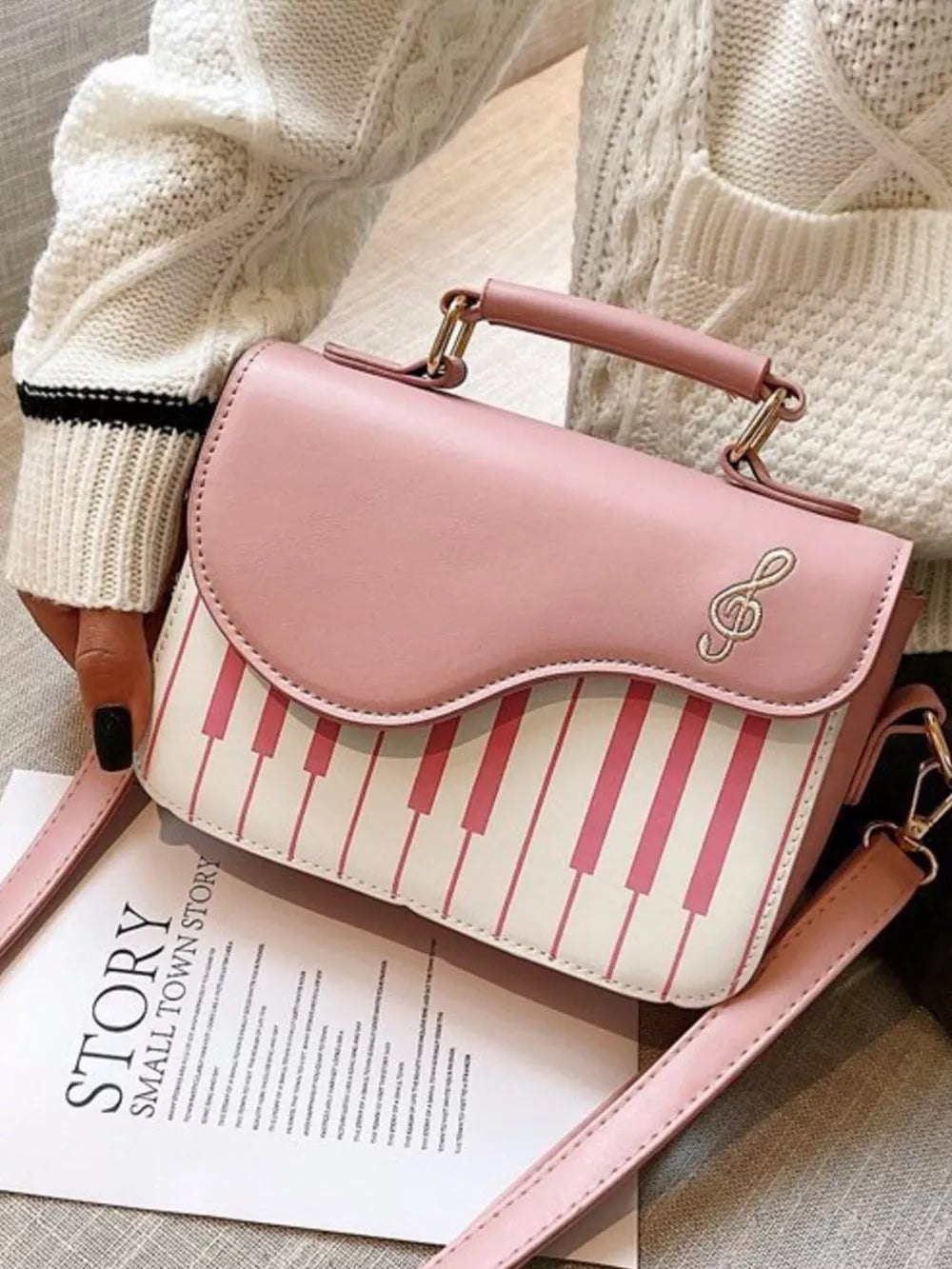 Pink and white piano key crossbody bag with treble clef detail