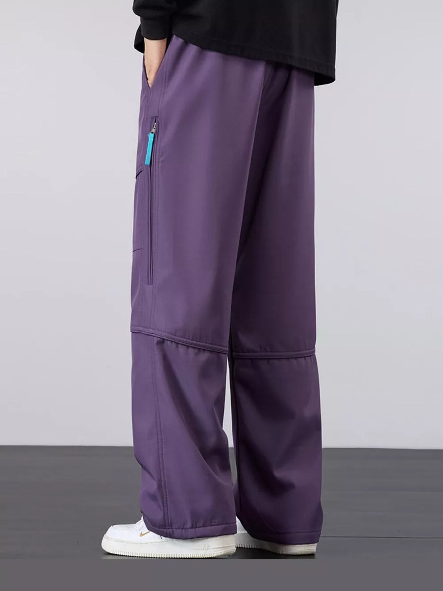 Purple cargo pants with loose fit and zippered pocket detail.