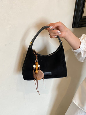 black with handbag with decorative charm